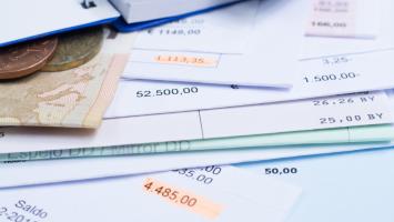 Mortgage and utility bills, foreign coins and banknote, calculator, different amounts