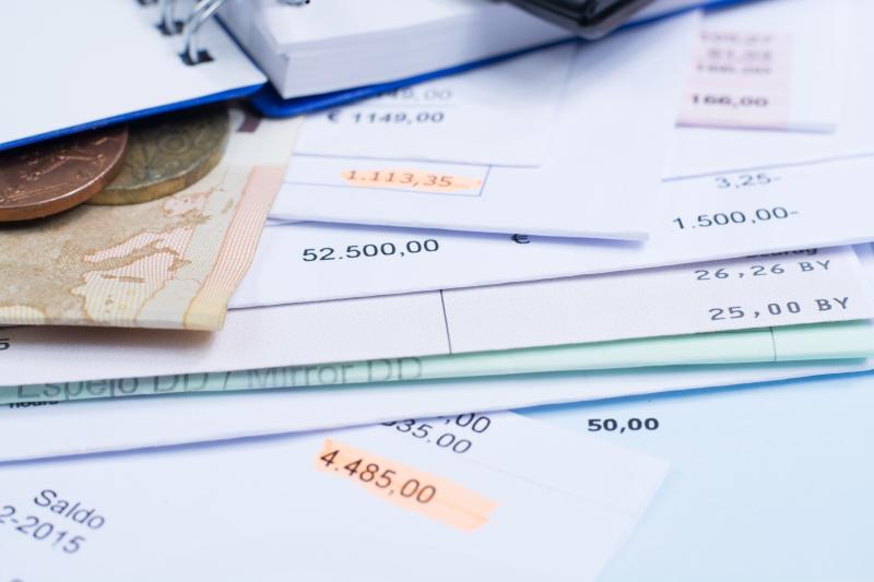 Mortgage and utility bills, foreign coins and banknote, calculator, different amounts