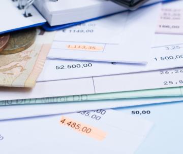 Mortgage and utility bills, foreign coins and banknote, calculator, different amounts